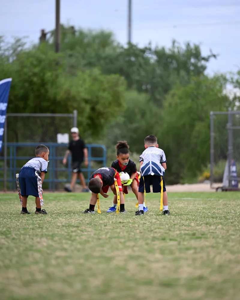 6U players lined up at the snap, the center bent over the ball