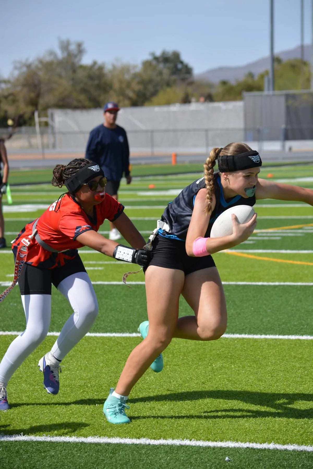 Girls division ball carrier fighting off a flag pull at Mt. View High School