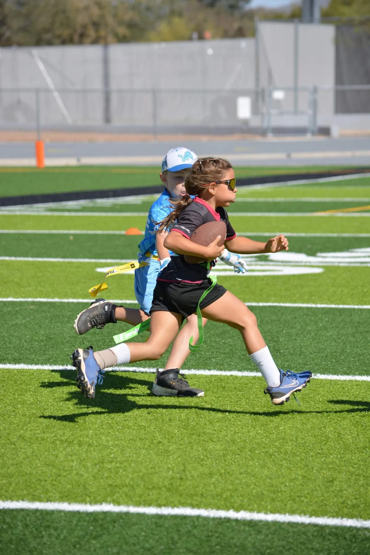 Young girls division player running with the football at Mt. View High School