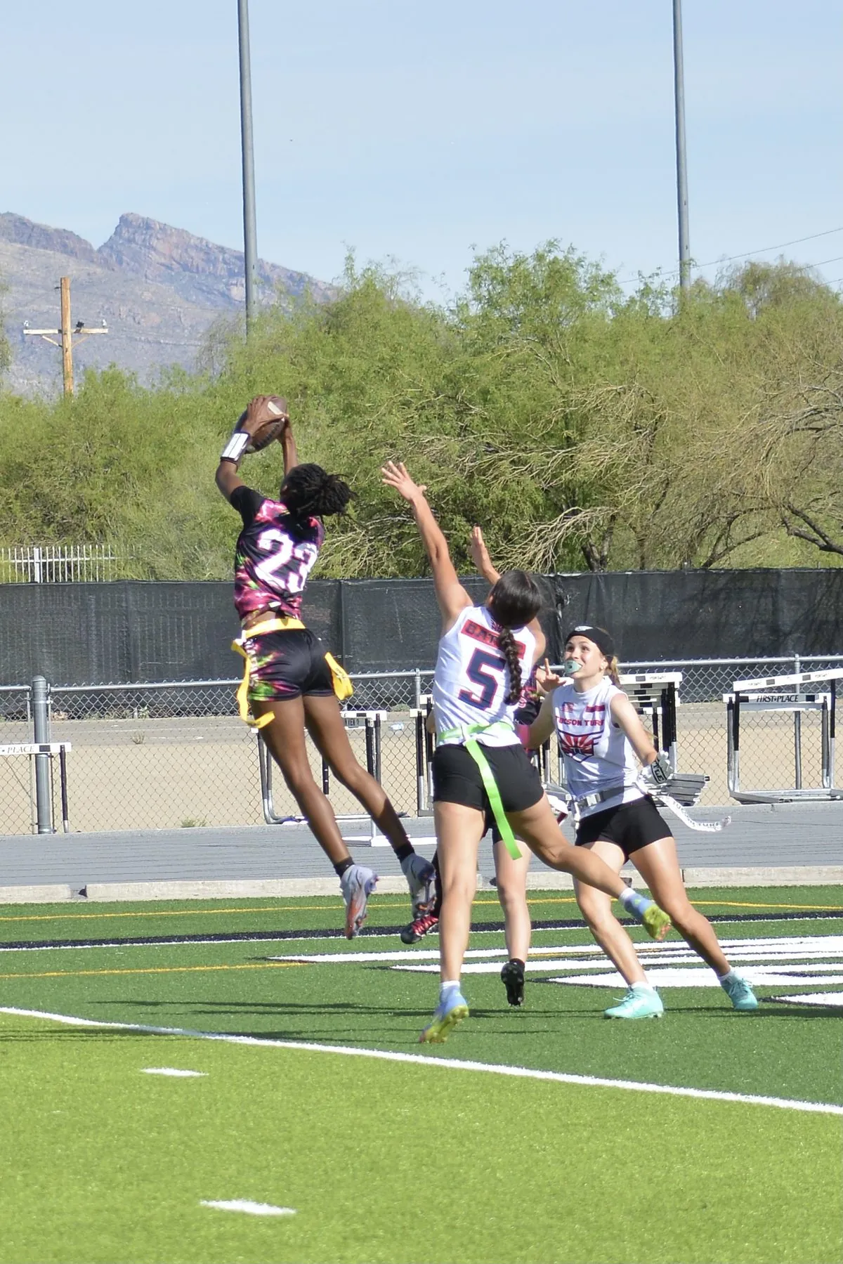 High school girls going up for a contested catch