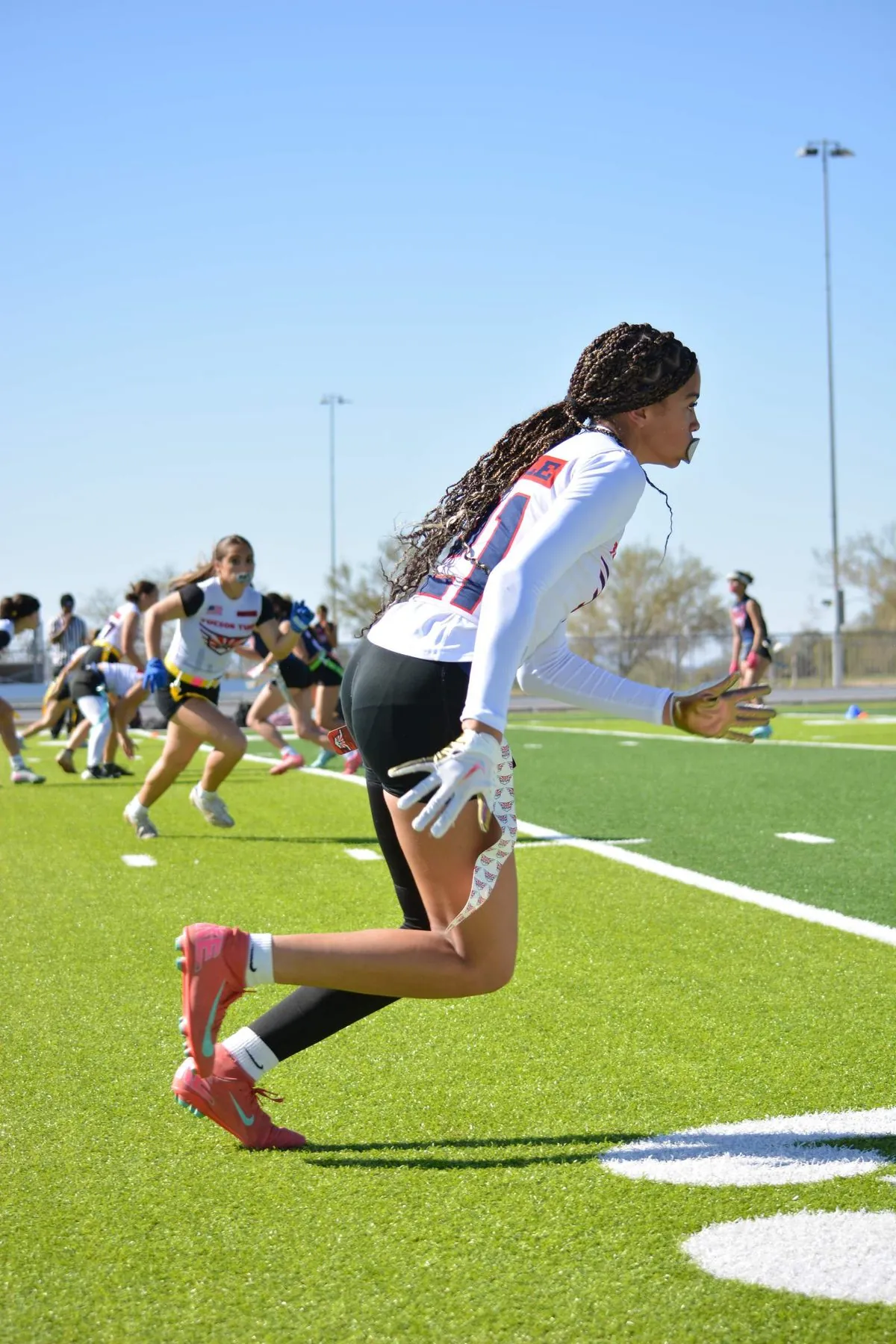 High school 7v7 receiver pulling in an over-the-shoulder catch